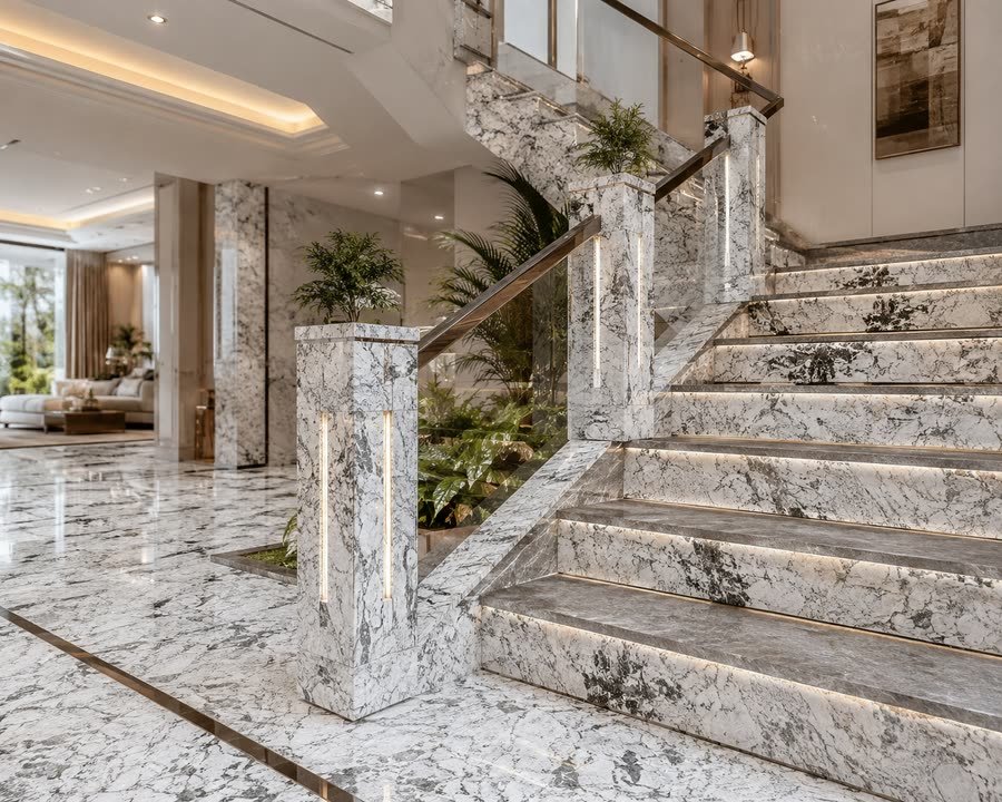 Rendered visualisation of an interior staircase and landing finished in white and grey veined stone, with lit vertical strips in the newel post, illuminated stair risers, a glass and metal balustrade and ferns in a planted recess.