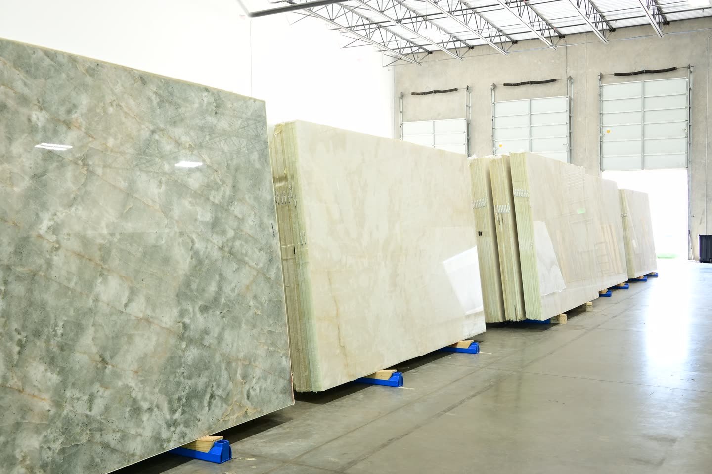 Stacked stone slabs on bearers beside an open loading door.