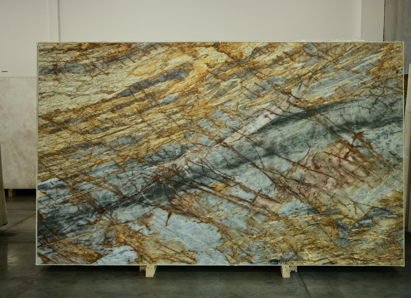 A stone slab with gold and blue-grey veining running diagonally across its face.