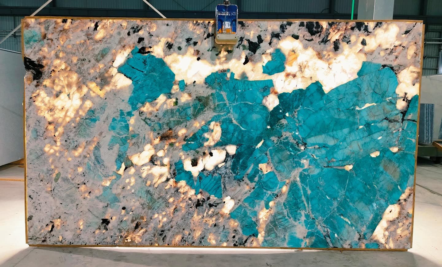 Amazonite — the slab lit from behind so the translucency and vein structure read through the stone.