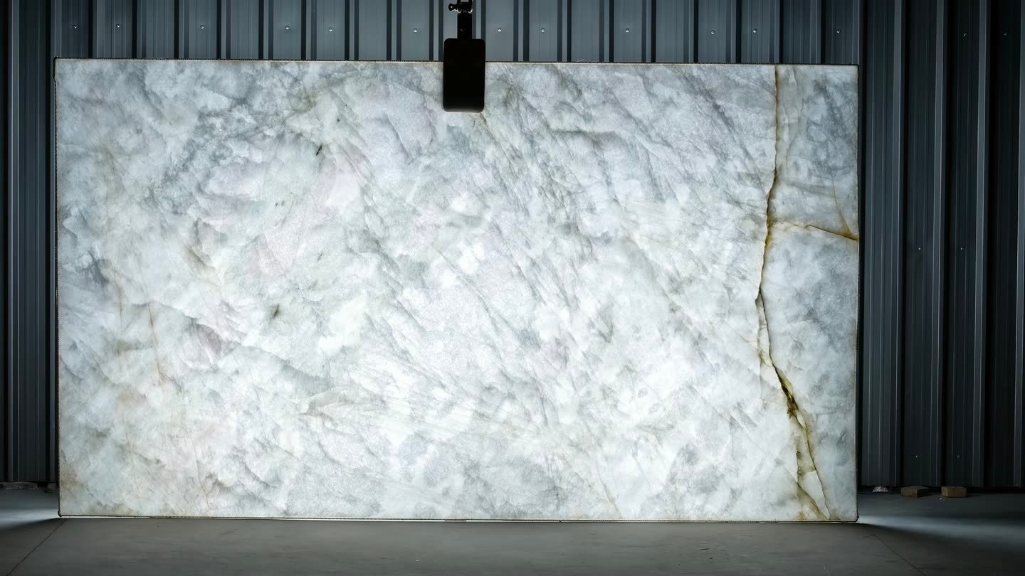 Crystallo Traslux — the slab lit from behind so the translucency and vein structure read through the stone.