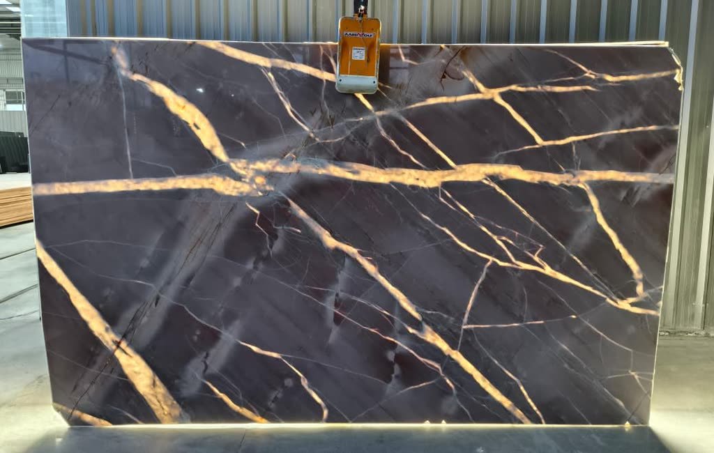 Splendido Brown — the slab lit from behind so the translucency and vein structure read through the stone.