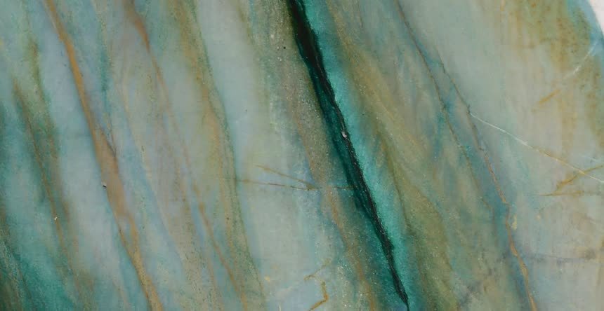 Mocamblu — close view of the stone surface. Teal and gold striations running the length of the slab.