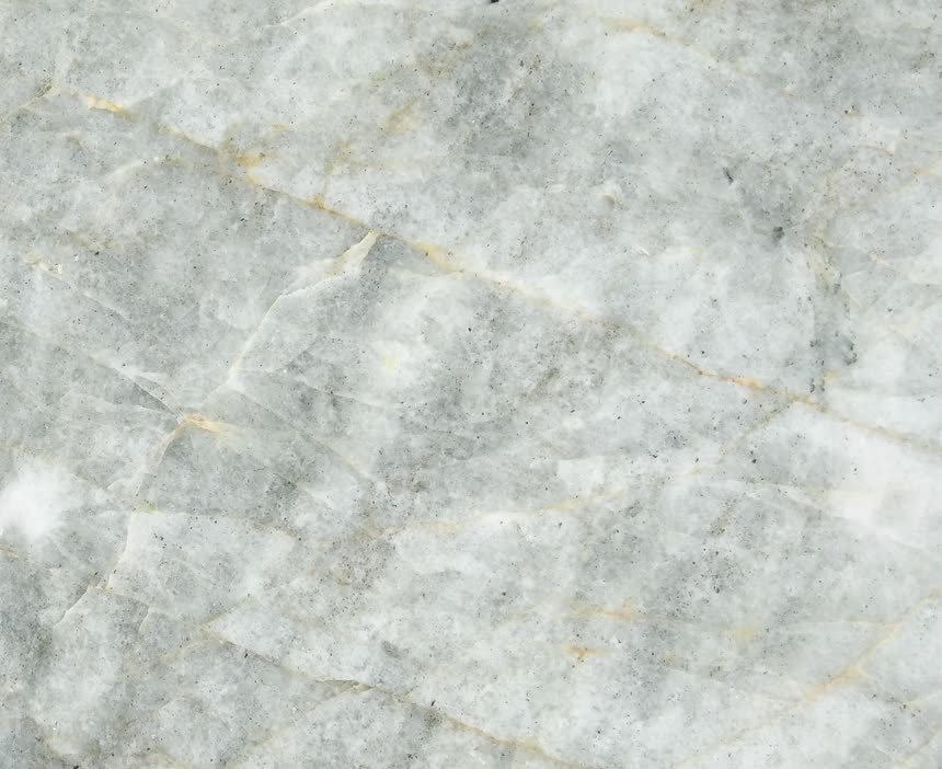 Verde Crystallo — close view of the stone surface. Pale green-white crystal with fine amber threads.